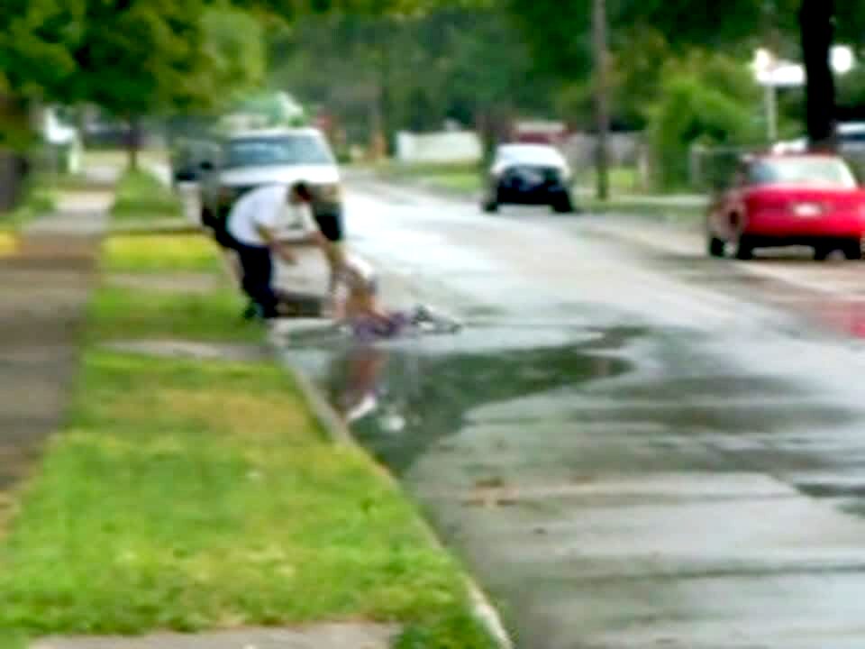 Video thumbnail showing: Little girl rides her bike with no training wheels for the first time. She crashes into a puddle.