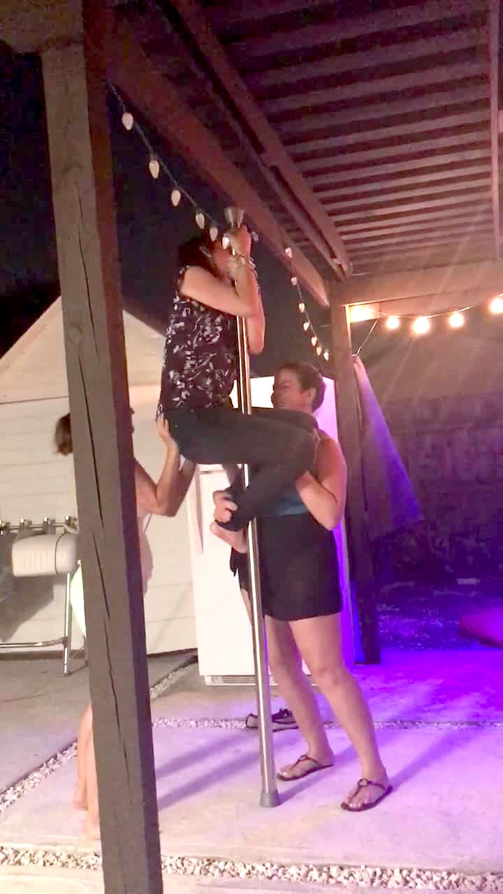 Video thumbnail showing: A woman climbs on a pole as two other woman hold her up.  The pole breaks and the woman falls.