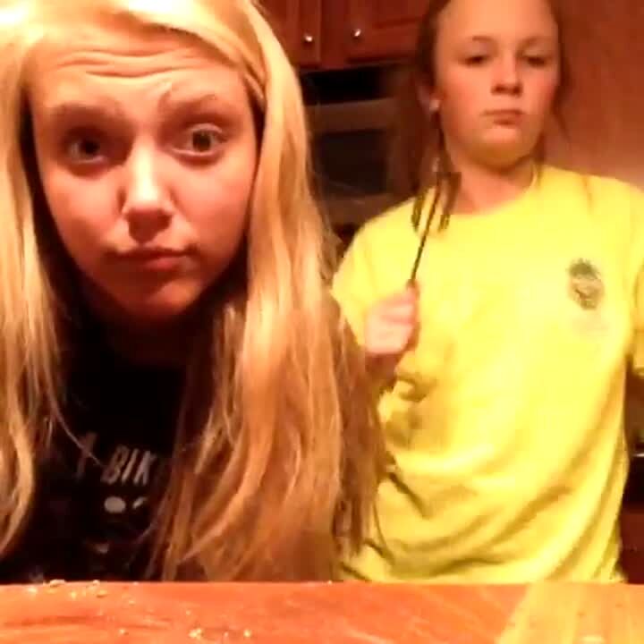 Video thumbnail showing: Two girls dance while cooking in the kitchen at home. One girl holding a whisk falls over.