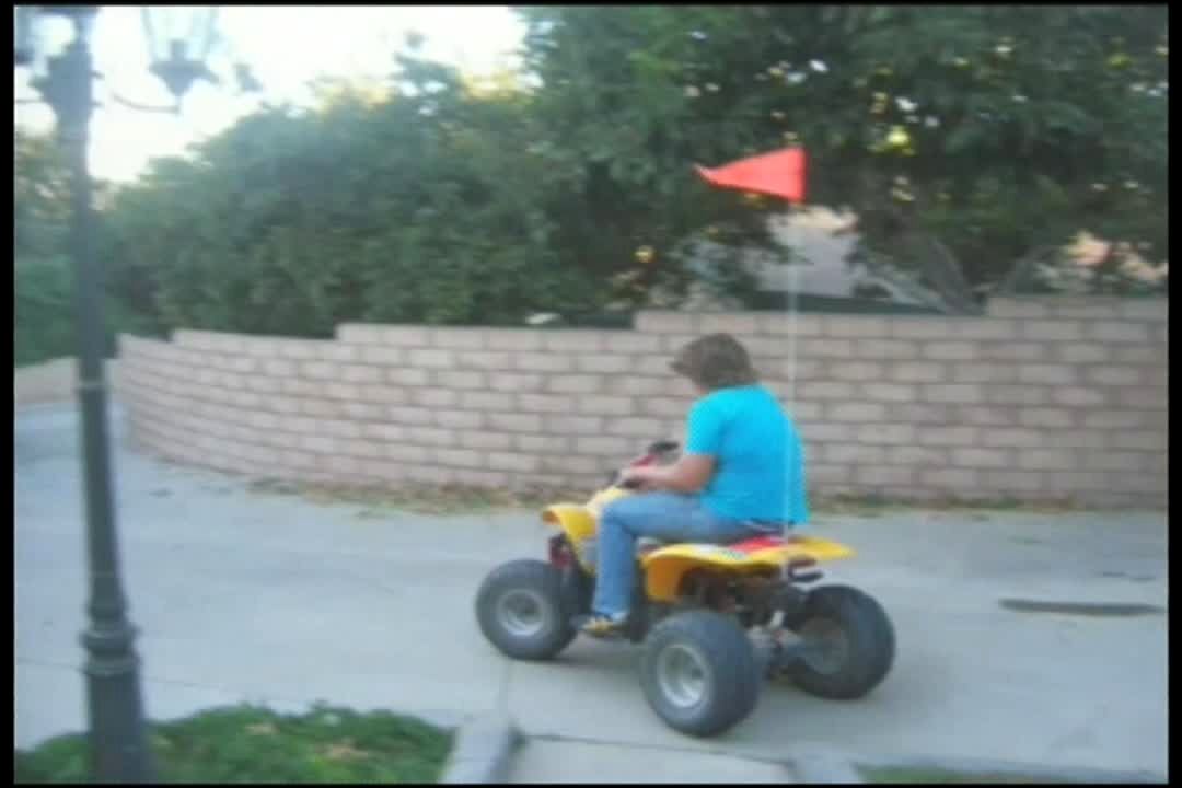 Video thumbnail showing: Teen boy tries to pop a wheelie on an ATV but he gets thrown over the handlebars when he hits the brake. 4 wheeler, motorbike. Good recovery.