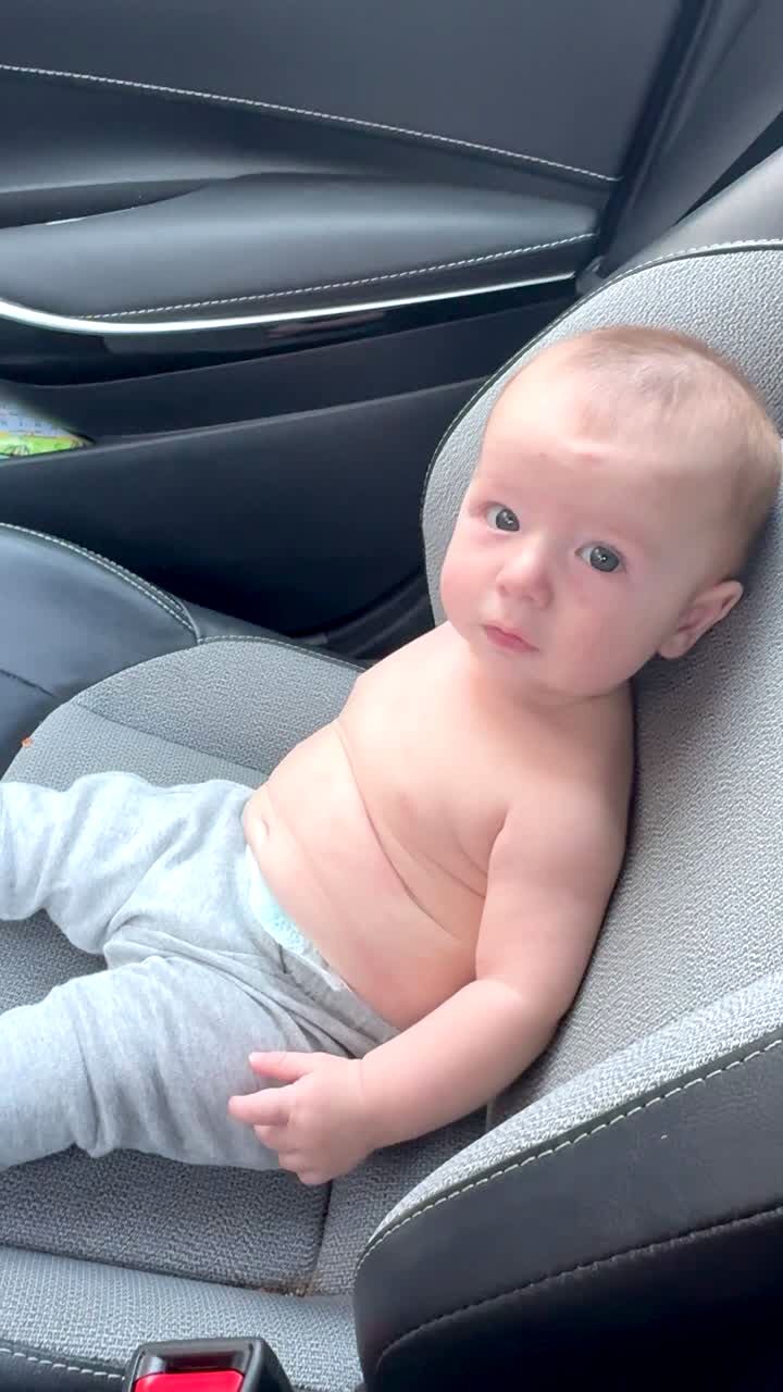 Video thumbnail showing: A man in the car tells a baby boy in the passenger seat how to start a car, then asks, \