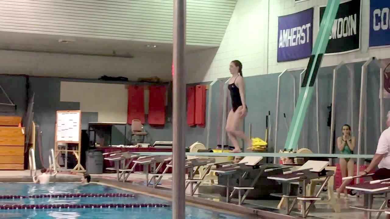 Video thumbnail showing: A teen girl at an indoor swimming pool jumps off a diving board and accidentally belly flops. Featured talent cleared only (the girl on the diving board).